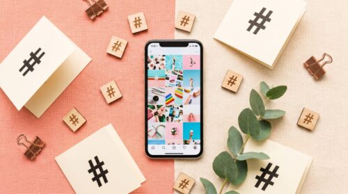 Móvil con una cuadrícula de fotos y fichas con el símbolo de hashtag, mejores hashtags para Instagram por categorías